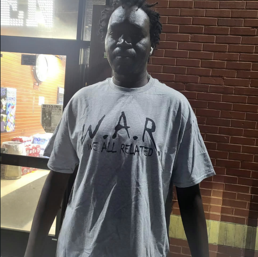 Man wearing a heather grey W.A.R. — We All Related t-shirt
