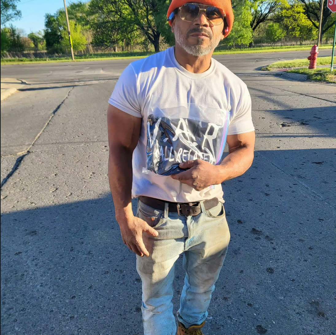 Man wearing a white W.A.R. t-shirt on the street